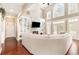 Inviting living room with high ceilings, a fireplace, custom built-ins, hardwood floors, and large windows for natural light at 3564 Brampton Dr., Myrtle Beach, SC 29588