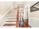Grand staircase with hardwood steps and iron railing leading to a bright and airy upper level at 3564 Brampton Dr., Myrtle Beach, SC 29588