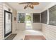 Charming screened-in porch featuring a ceiling fan, a rug, and outdoor access at 3564 Brampton Dr., Myrtle Beach, SC 29588