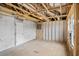 Unfinished basement space with exposed framing, concrete floor, and a door leading to another room at 367 Broughton Dr., Myrtle Beach, SC 29579