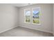 Bright, carpeted bedroom with two windows offering neighborhood and sky views at 367 Broughton Dr., Myrtle Beach, SC 29579