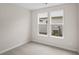 Neutral carpeted bedroom showcasing two bright windows offering views of the outdoor landscape at 367 Broughton Dr., Myrtle Beach, SC 29579