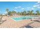 Community pool featuring lounge chairs, umbrellas, and lush landscaping at 3672 White Wing Circle, Myrtle Beach, SC 29579