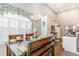 Cozy dining room with a wooden table, decorative chandelier, and lots of natural light at 3672 White Wing Circle, Myrtle Beach, SC 29579