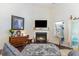 Cozy living room featuring a fireplace, TV, and a decorative rug on hardwood floors at 3672 White Wing Circle, Myrtle Beach, SC 29579
