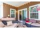 Relaxing covered patio with comfortable seating, windows, and a sliding glass door at 3672 White Wing Circle, Myrtle Beach, SC 29579