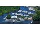 Aerial view of a marina, showcasing yachts, docks, landscaping, and waterfront restaurant for a scenic lifestyle at 3772 Brown Bark Ln., Murrells Inlet, SC 29576