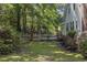 Spacious backyard with a manicured lawn, white picket fence, and lush greenery at 3772 Brown Bark Ln., Murrells Inlet, SC 29576