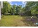 Large backyard featuring a trampoline and seating area to enjoy outdoor activities at 3772 Brown Bark Ln., Murrells Inlet, SC 29576