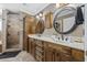 Bathroom featuring a double vanity, custom cabinets, and tiled shower at 3772 Brown Bark Ln., Murrells Inlet, SC 29576