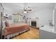 Bedroom with a decorative fireplace, hardwood floors, and window shutters at 3772 Brown Bark Ln., Murrells Inlet, SC 29576