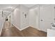 Hallway with dark hardwood floors, doors, and decorative crosses on the wall at 3772 Brown Bark Ln., Murrells Inlet, SC 29576