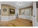 Hallway features natural light, wainscoting, and hardwood flooring at 3772 Brown Bark Ln., Murrells Inlet, SC 29576