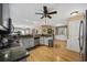 Open-concept kitchen with granite countertops, stainless steel appliances, and hardwood floors at 3772 Brown Bark Ln., Murrells Inlet, SC 29576