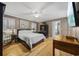 Comfortable bedroom with hardwood floors, ceiling fan, and ensuite bath at 3772 Brown Bark Ln., Murrells Inlet, SC 29576