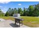 Spacious backyard featuring a well-maintained lawn, concrete patio, BBQ grill, and storage shed at 3926 Long Avenue Ext., Conway, SC 29527