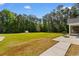 Expansive backyard featuring a lush lawn, mature trees, and a concrete patio, ideal for outdoor activities at 3926 Long Avenue Ext., Conway, SC 29527