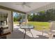 Cozy screened-in patio with ceiling fan and outdoor seating, perfect for relaxing and enjoying the backyard view at 3926 Long Avenue Ext., Conway, SC 29527