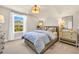 Bedroom showcasing a large window, neutral walls, and wicker furniture at 402 Sun Colony Blvd., Longs, SC 29568