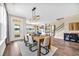 Open concept dining room and living space, with hardwood floors and modern lighting at 402 Sun Colony Blvd., Longs, SC 29568