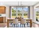 Bright dining room with natural light, table and chairs, with views of backyard through the large windows at 402 Sun Colony Blvd., Longs, SC 29568