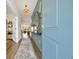 Inviting entryway features a stylish light fixture, a decorative mirror and view into the living room at 402 Sun Colony Blvd., Longs, SC 29568