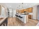 Open-concept kitchen featuring an island with bar seating, wooden cabinetry, and stainless-steel appliances at 402 Sun Colony Blvd., Longs, SC 29568