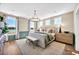 Spacious main bedroom with water view, chandelier, bench, and large windows at 402 Sun Colony Blvd., Longs, SC 29568