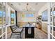 Well-lit home office with large windows, a sleek desk, and sophisticated decor at 402 Sun Colony Blvd., Longs, SC 29568