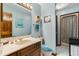 Charming bathroom featuring light blue patterned walls, single vanity, and a shower with sliding glass doors at 4046 Fairway Lakes Dr. # 4046, Myrtle Beach, SC 29579