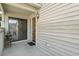 Covered front porch with a sliding glass door entry and exterior lighting, creating a welcoming entrance at 4046 Fairway Lakes Dr. # 4046, Myrtle Beach, SC 29579