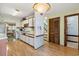 Bright kitchen with white cabinets, wood laminate floors, and an open design leading to the dining area at 4046 Fairway Lakes Dr. # 4046, Myrtle Beach, SC 29579