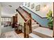Elegant staircase with carpeted steps and wooden banister with views into the front room and artistic wall decorations at 4046 Fairway Lakes Dr. # 4046, Myrtle Beach, SC 29579