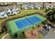 Aerial view of a well-maintained tennis court surrounded by landscaping and nearby parking at 4046 Fairway Lakes Dr. # 4046, Myrtle Beach, SC 29579
