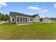 Rear view of the home with a screened-in porch and well-maintained lawn at 4067 Ridgewood Dr., Conway, SC 29526