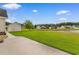 Expansive backyard features a concrete patio, lush lawn, and a serene pond view at 4067 Ridgewood Dr., Conway, SC 29526