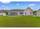 Back exterior view showcasing screened porch and brick foundation at 4067 Ridgewood Dr., Conway, SC 29526