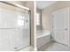 Bright bathroom featuring a tub, glass enclosed shower, and a window at 4067 Ridgewood Dr., Conway, SC 29526