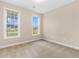 Bright bedroom features two large windows and neutral carpeting, ready for personalization at 4067 Ridgewood Dr., Conway, SC 29526