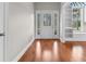 Welcoming foyer with hardwood floors, decorative front door, and built-in shelving at 4067 Ridgewood Dr., Conway, SC 29526