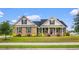 Charming brick home with manicured lawn, lush landscaping, and inviting front porch at 4067 Ridgewood Dr., Conway, SC 29526