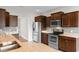 Well-equipped kitchen with stainless steel appliances, granite counters, and dark wood cabinetry at 4067 Ridgewood Dr., Conway, SC 29526