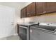 Well-equipped laundry room with cabinetry, granite countertops, and modern washer and dryer units at 4067 Ridgewood Dr., Conway, SC 29526