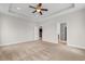The main bedroom includes carpet flooring, neutral paint, ceiling fan, and doorways to the ensuite bath and kitchen at 4067 Ridgewood Dr., Conway, SC 29526