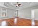 Spacious main bedroom featuring hardwood floors, a tray ceiling, and plenty of natural light at 4067 Ridgewood Dr., Conway, SC 29526