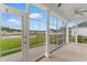 Enclosed porch with picturesque views of the backyard and pond, perfect for relaxing outdoors at 4067 Ridgewood Dr., Conway, SC 29526
