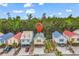 Aerial view of colorful beach houses with an indicator pin over the property and lush greenery in the background at 4341 Grande Harbour Blvd., Little River, SC 29566