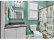 Well-lit bathroom with a stylish granite sink, toilet, and a shower with a decorative curtain at 4341 Grande Harbour Blvd., Little River, SC 29566
