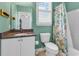 Bathroom featuring a toilet, sink, and shower, with a stylish tropical shower curtain at 4341 Grande Harbour Blvd., Little River, SC 29566
