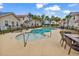 A community pool surrounded by sun loungers and tables, with a line of vacation homes in the background at 4341 Grande Harbour Blvd., Little River, SC 29566